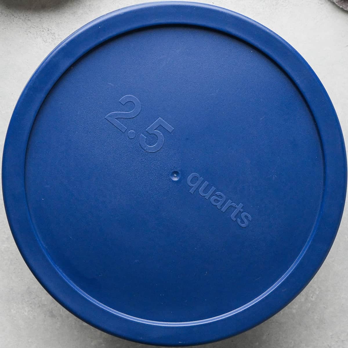 a glass container with a lid with 3 Bean Salad inside to be chilled in the refrigerator