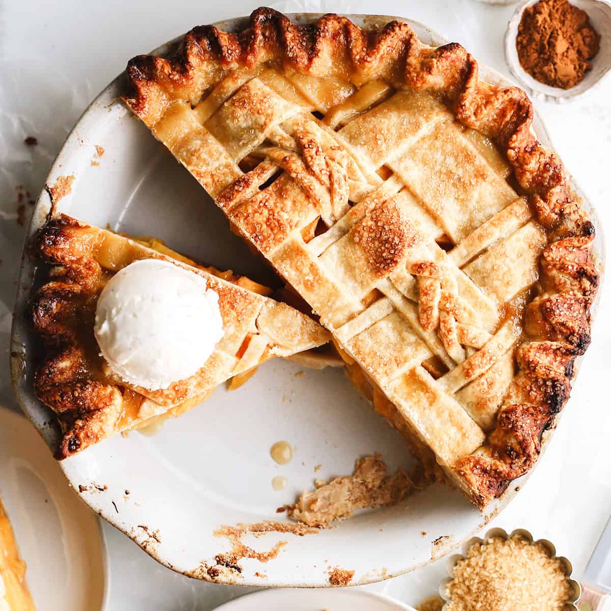 overhead view of a baked Butter Pie Crust with a slice cut out and ice cream on top