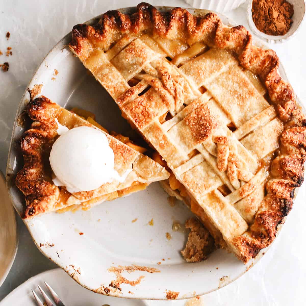 overhead view of a baked Butter Pie Crust with a slice cut out and ice cream on top