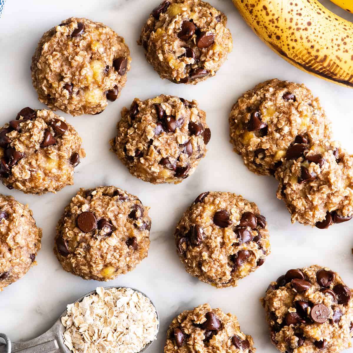 These banana oatmeal cookies are easy to make with a few simple ingredients in 20 minutes. Banana oat cookies are a delicious breakfast, snack or healthy dessert - add chocolate chip or your favorite mix-ins to make them extra-special! overhead photo of 11 Banana Oatmeal Cookies