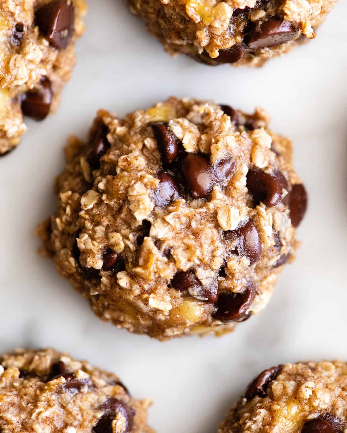 overhead photo of a banana oatmeal cookie with 4 others around it