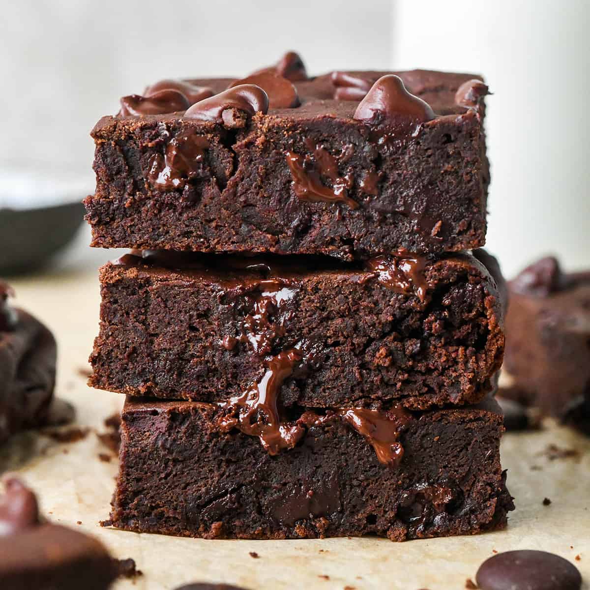 The BEST Black Bean Brownies Recipe ever + a video! I make these embarrassingly often because they are the perfect healthy dessert that's ready in 30 minutes and are delicious straight from the oven. #dairyfree #glutenfree #brownies #chocolate #blackbeans #blackbeanbrownies #vitamix #recipe #video a stack of 3 black bean brownies with melty chocolate chips