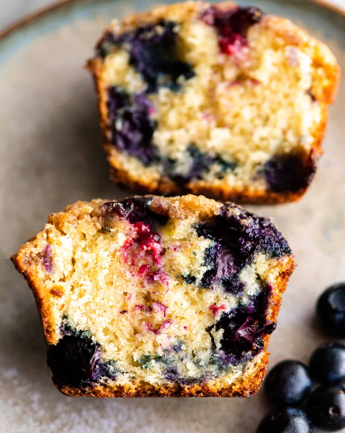 These are the best blueberry muffins ever! This blueberry muffin recipe results in moist, buttery blueberry muffins with a perfect texture that are loaded with fresh blueberries and topped with a crumb topping. They're easy to make in only 30 minutes and no mixer required! #blueberrymuffins #muffins #recipe #joyfoodsunshine #breakfast #brunch up close overhead view of the inside of a blueberry muffin