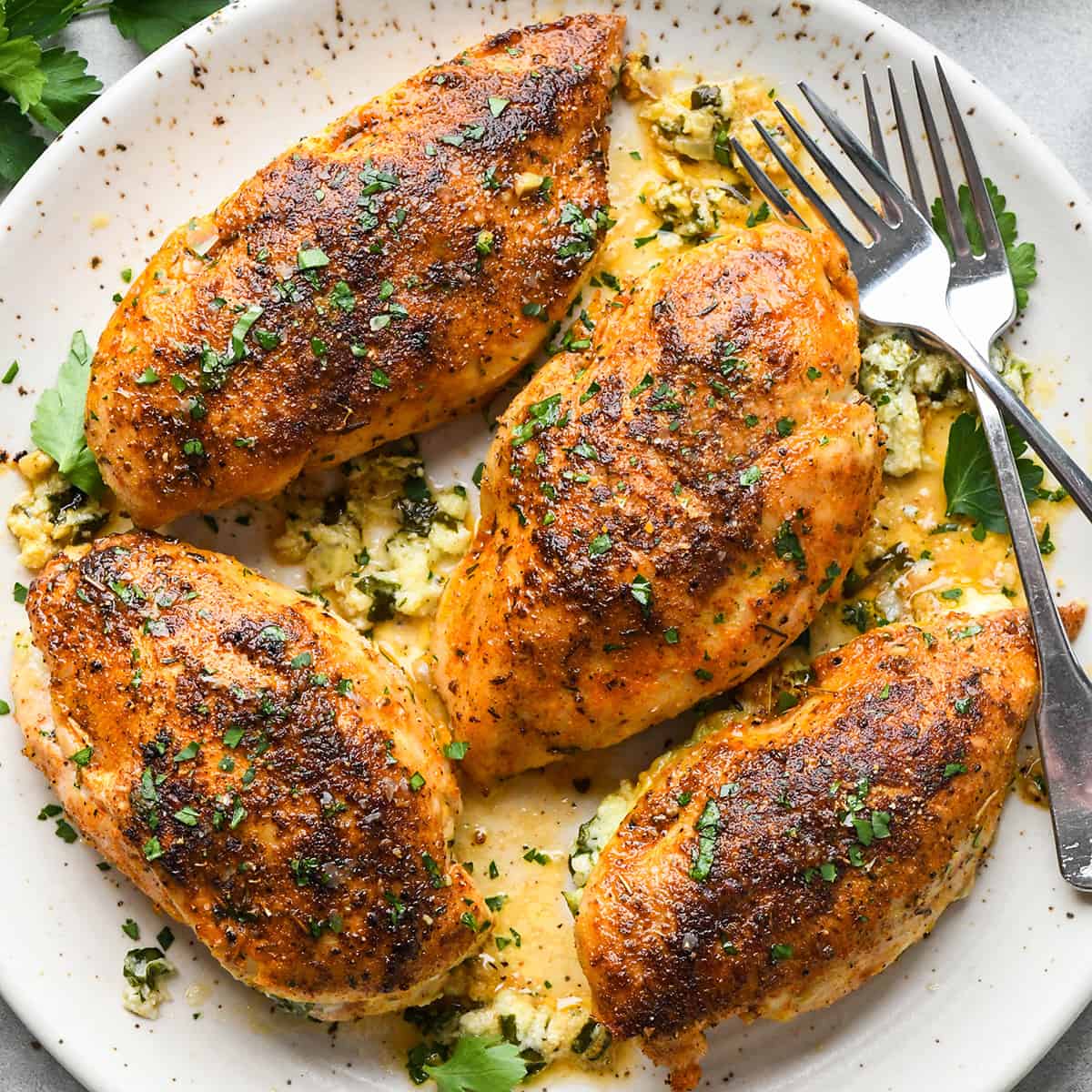 4 chicken breasts on a plate