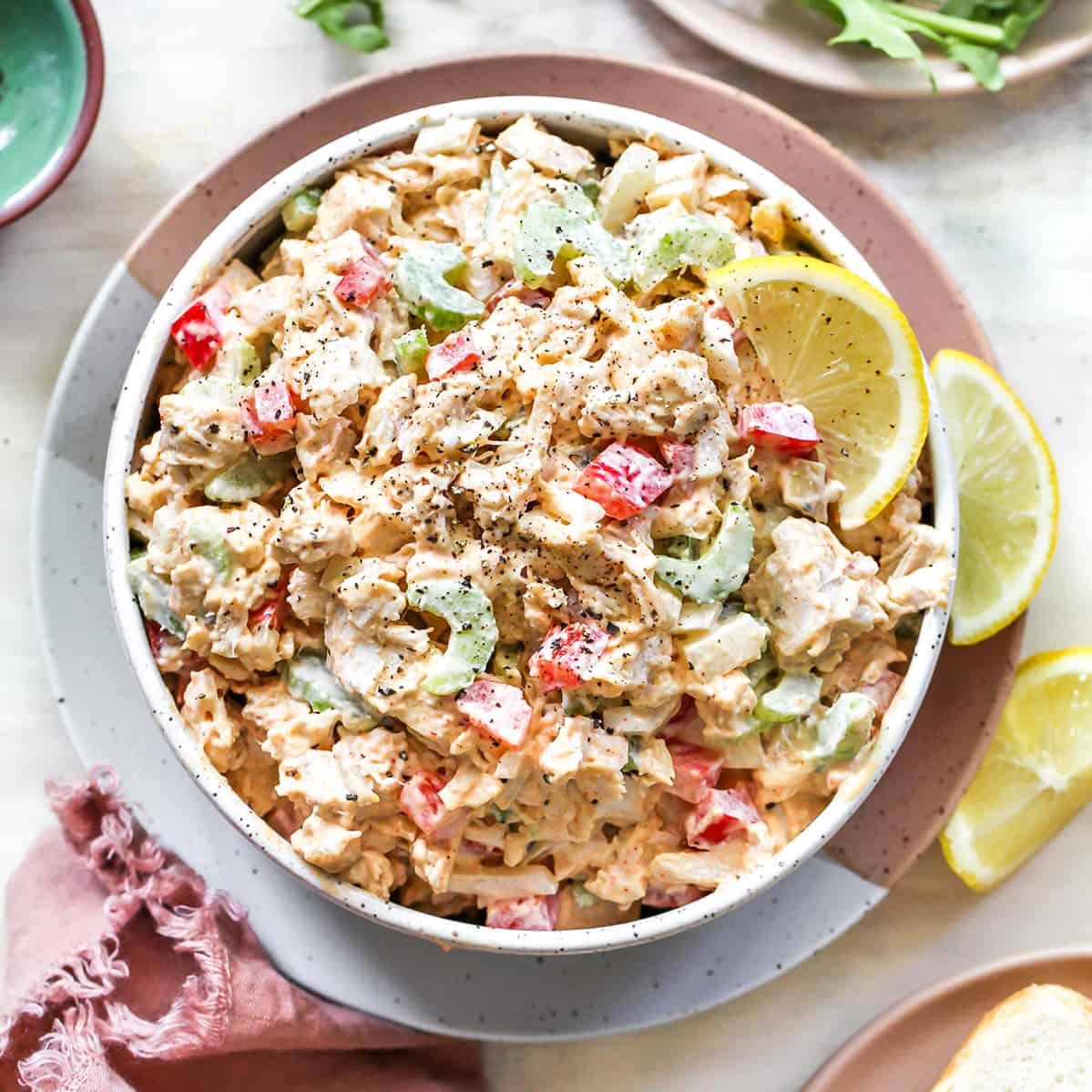 This Chicken Salad Recipe is easy to make with only a handful of simple ingredients. Serve as chicken salad sandwiches or on top of a bed of greens for a delicious, flavorful and light summertime meal! Watch the video and follow our step-by-step instructions to learn how to make chicken salad at home! Overhead view of a bowl of chicken salad