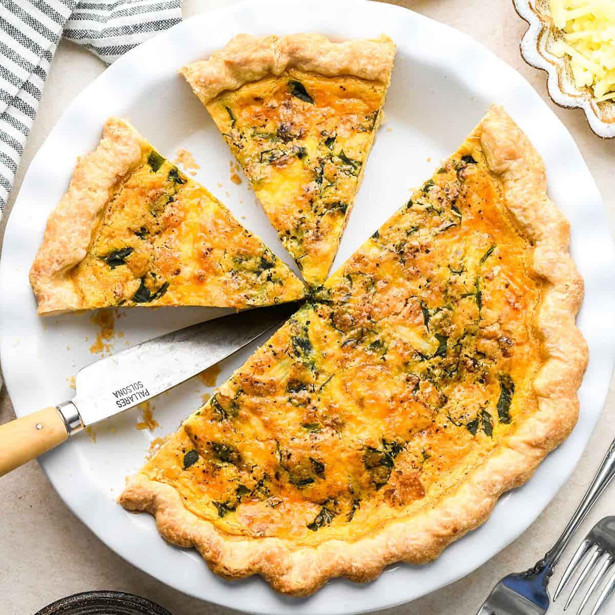 quiche in a pie dish with two slices cut