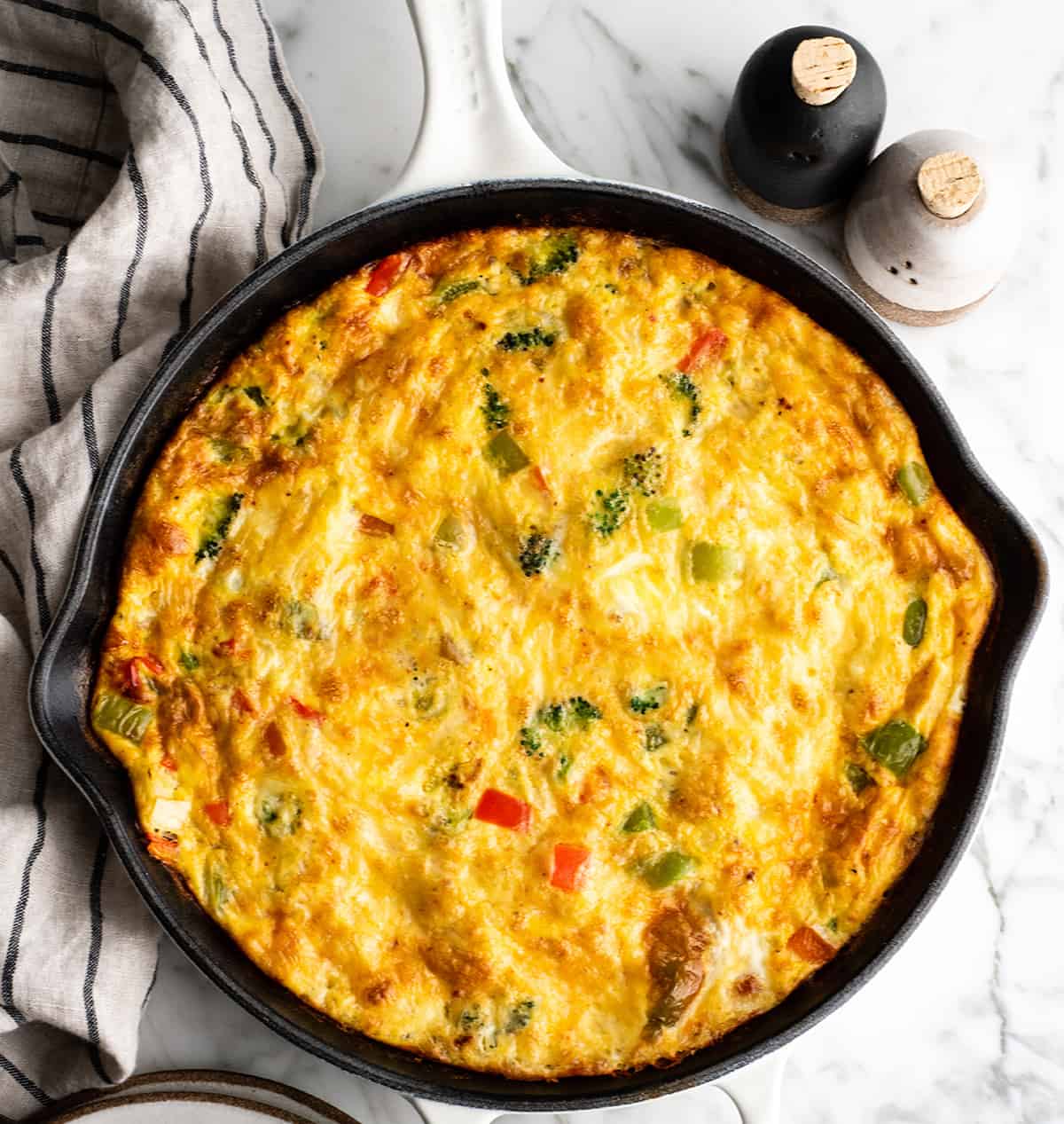 overhead view of a vegetable frittata in a cast iron skillet