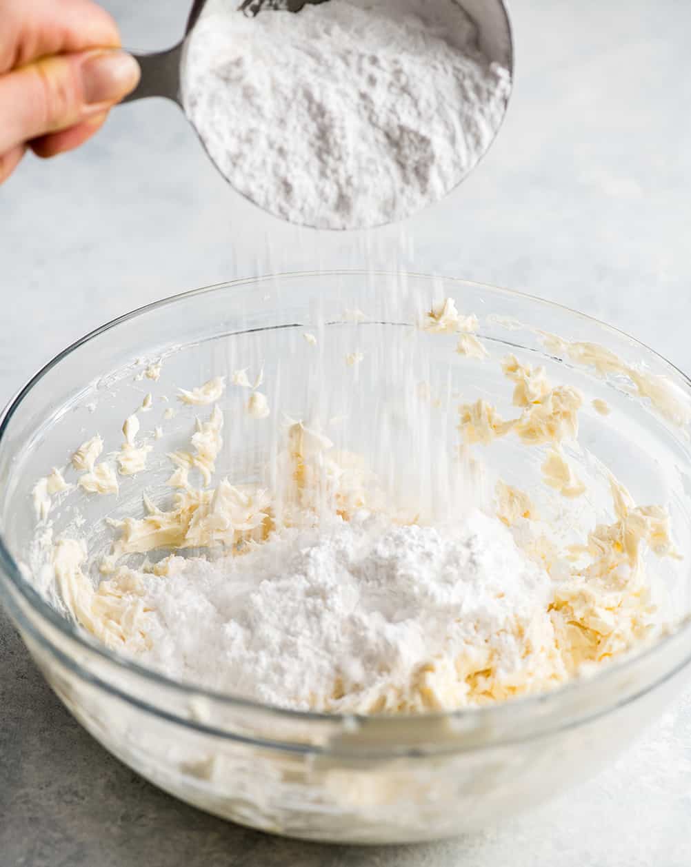 This is the Best Homemade Cinnamon Rolls Recipe EVER! These gooey cinnamon rolls are even better than Cinnabon cinnamon rolls, and are topped with a delicious cream cheese frosting! They're easy to make and can be prepared the day before and left to rise overnight in the refrigerator. front photo showing how to make cream cheese frosting for cinnamon rolls