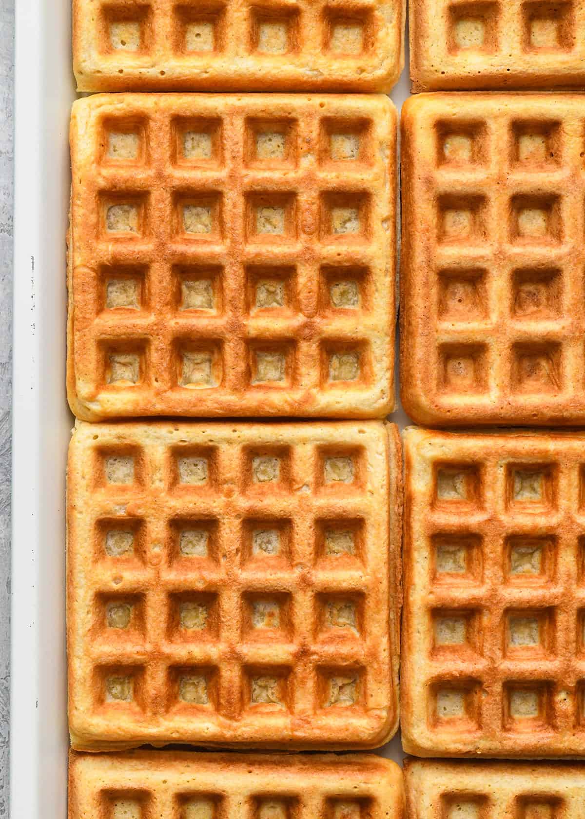 8 Homemade Waffles on a baking sheet to keep warm