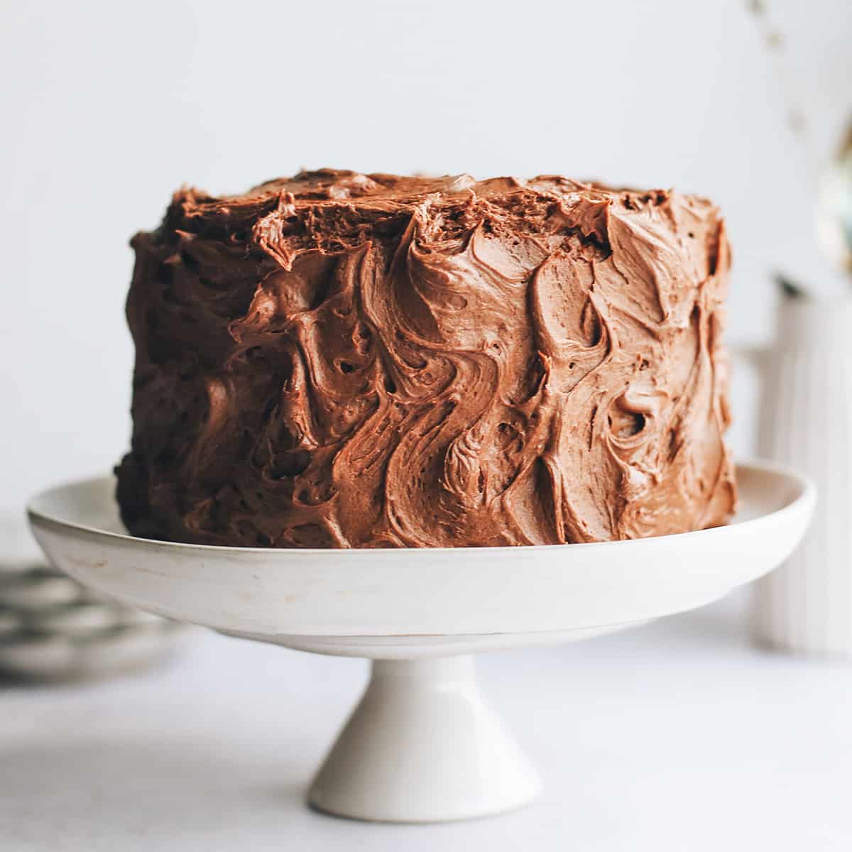photo of a Yellow Cake frosting with chocolate frosting on a cake plate