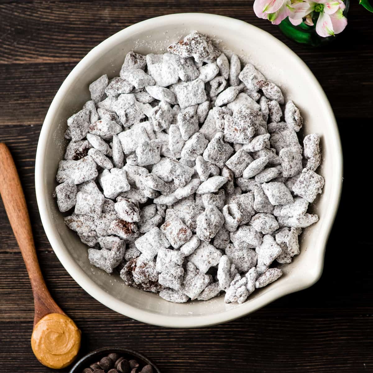 The Best Puppy Chow Recipe EVER! OnThe Best Puppy Chow Recipe (AKA: Muddy Buddies) EVER! Only 4 ingredients (no butter) and a few minutes results in an irresistible dessert loaded with chocolate and peanut butter! The perfect sweet treat to feed a crowd! ly 4 ingredients and a few minutes results in an irresistible dessert loaded with chocolate and peanut butter! The perfect sweet treat to feed a crowd! AKA: Muddy Buddies! Plus, it's gluten-free, dairy-free, and vegan! #puppychow #muddybuddies #dessert #glutenfree #dairyfree #vegan #chocolate #peanutbutter Overhead view of a bowl of the best puppy chow recipe in a bowl