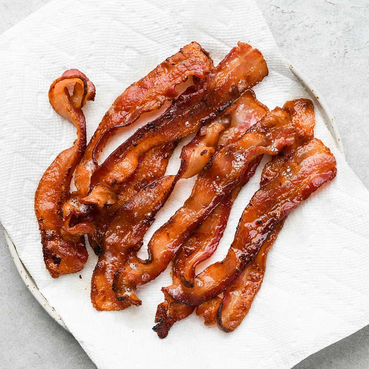 cooked bacon on a plate lined with paper towels to use in this Broccoli Salad recipe