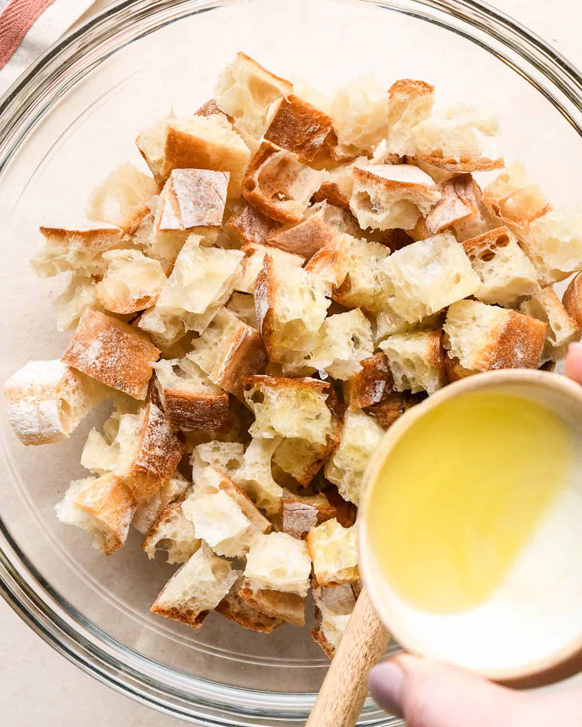 How to Make Burrata Salad - making croutons in a glass bowl