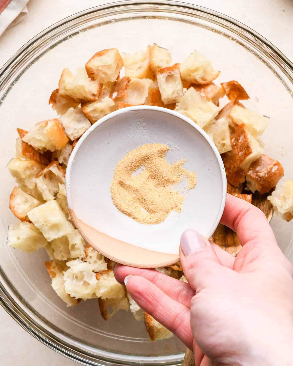 How to Make Burrata Salad - making croutons in a glass bowl