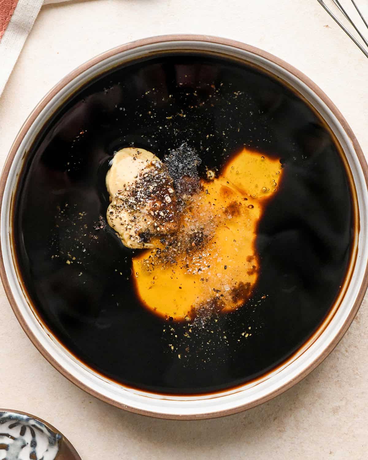 making burrata salad dressing in a small bowl - ingredients before mixing