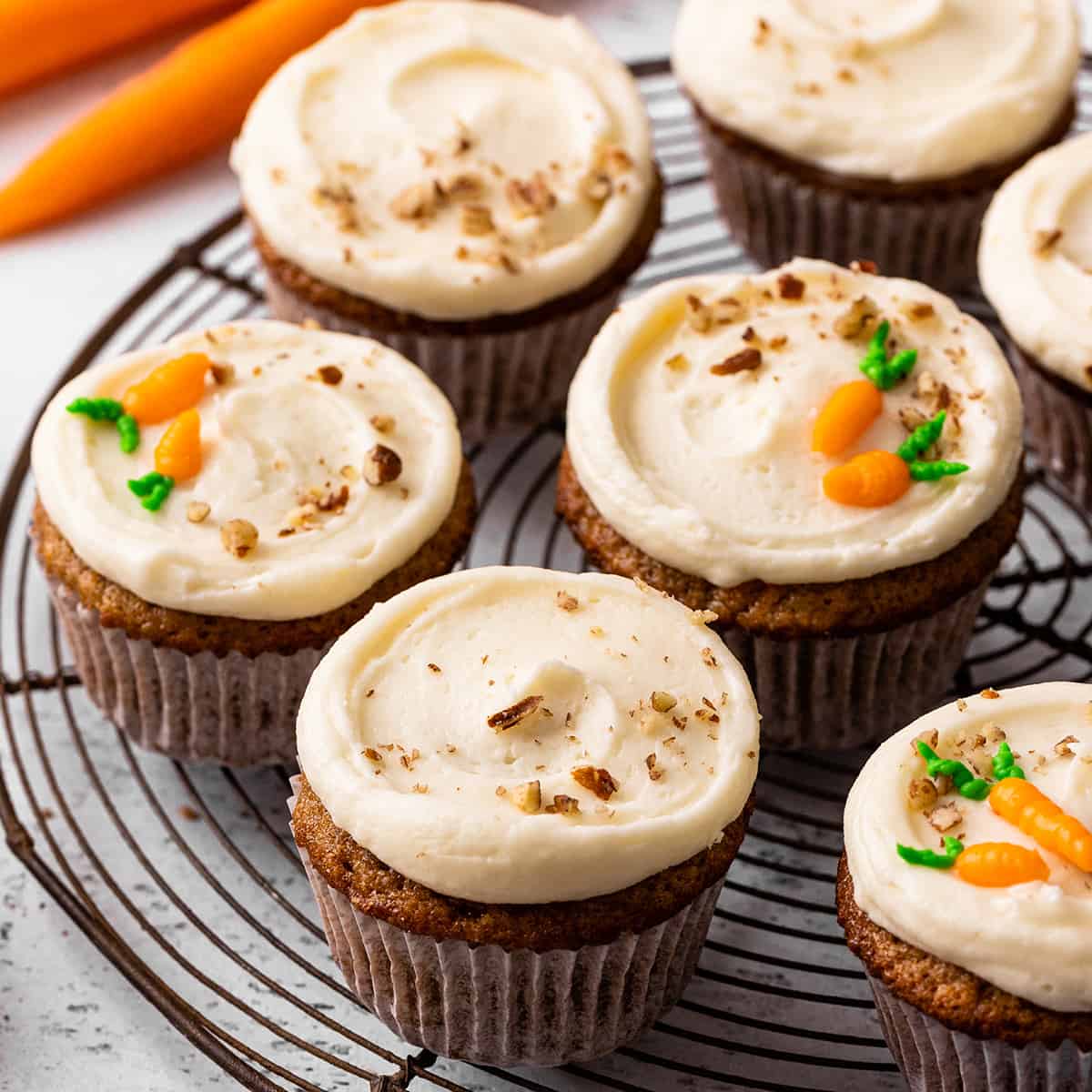 7 frosted carrot cake cupcakes on a wire cooling rack