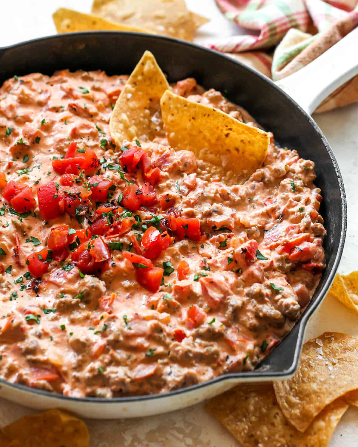 This cream cheese sausage dip is an easy appetizer made with 8 ingredients, in one skillet in 20 minutes. You can easily adjust the spice to make it mild or hot! Serve it with chips, crackers, or veggies for a delicious, low-carb, warm appetizer that will be the hit of any party. Cream Cheese Sausage Dip in a skillet with chips
