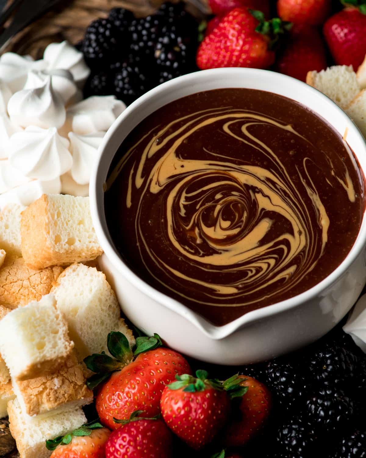 If chocolate & peanut butter is your love language, then you need to make this Dairy-Free Chocolate Peanut Butter Fondue recipe! It's the perfect desert for Valentine's Day or to serve at a Galentine's Day Brunch! #vegan #glutenfree #dairyfree #chocolate #peanutbutter #fondue #dessert Overhead view of Chocolate Peanut Butter Fondue with a peanut butter swirl