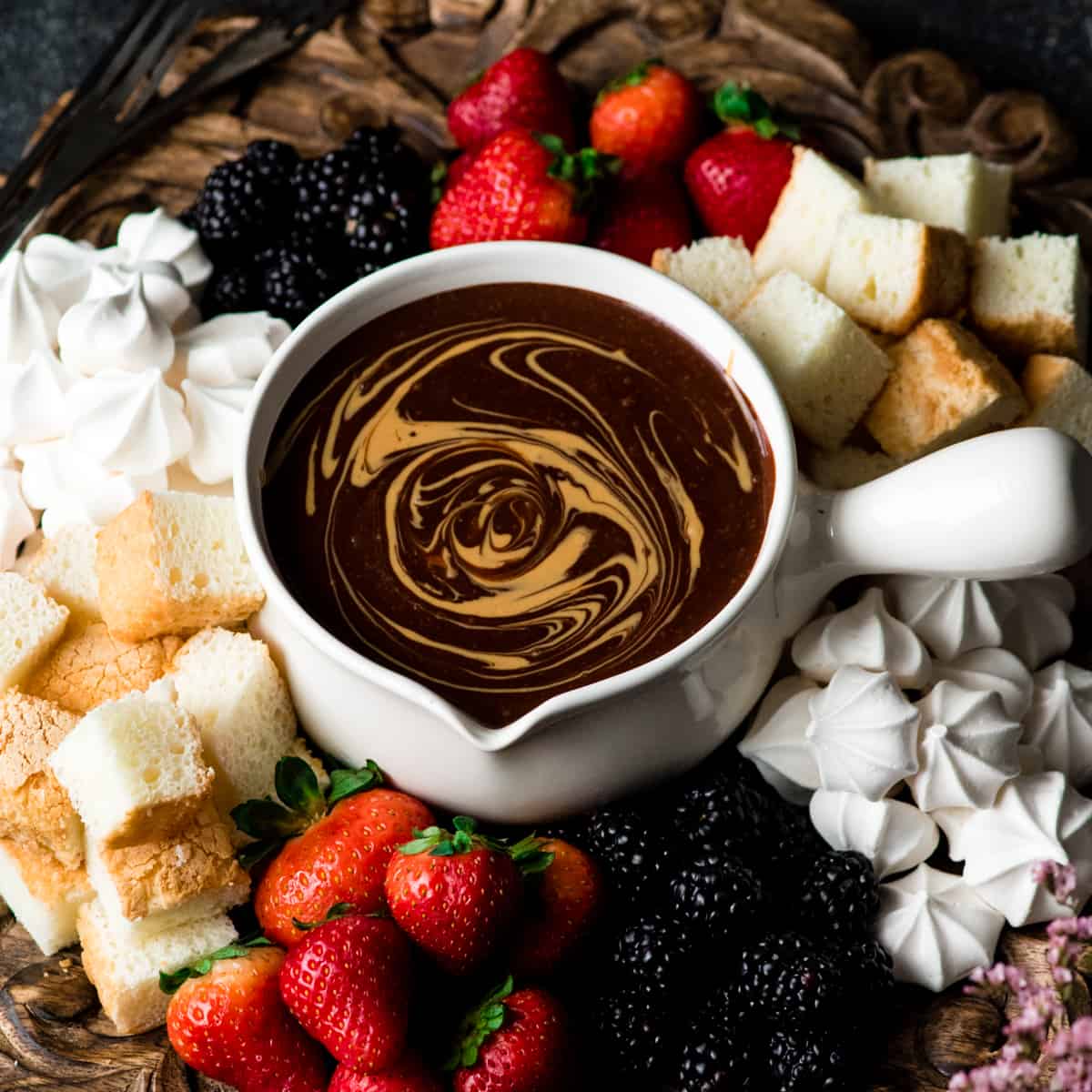 If chocolate & peanut butter is your love language, then you need to make this Dairy-Free Chocolate Peanut Butter Fondue recipe! It's the perfect desert for Valentine's Day or to serve at a Galentine's Day Brunch! #vegan #glutenfree #dairyfree #chocolate #peanutbutter #fondue #dessert Overhead view of Chocolate Peanut Butter Fondue with a peanut butter swirl