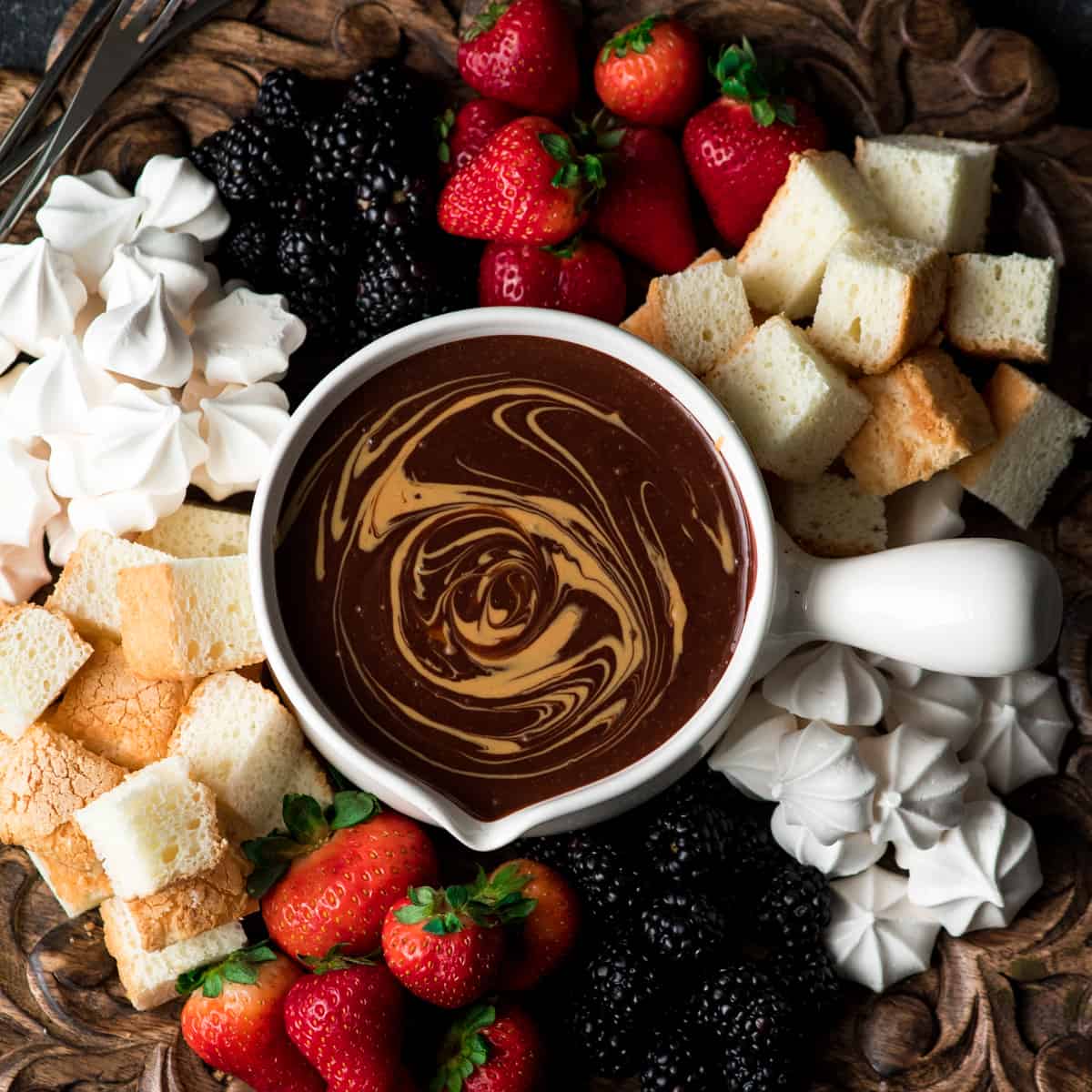 If chocolate & peanut butter is your love language, then you need to make this Dairy-Free Chocolate Peanut Butter Fondue recipe! It's the perfect desert for Valentine's Day or to serve at a Galentine's Day Brunch! #vegan #glutenfree #dairyfree #chocolate #peanutbutter #fondue #dessert Overhead view of Chocolate Peanut Butter Fondue with a peanut butter swirl