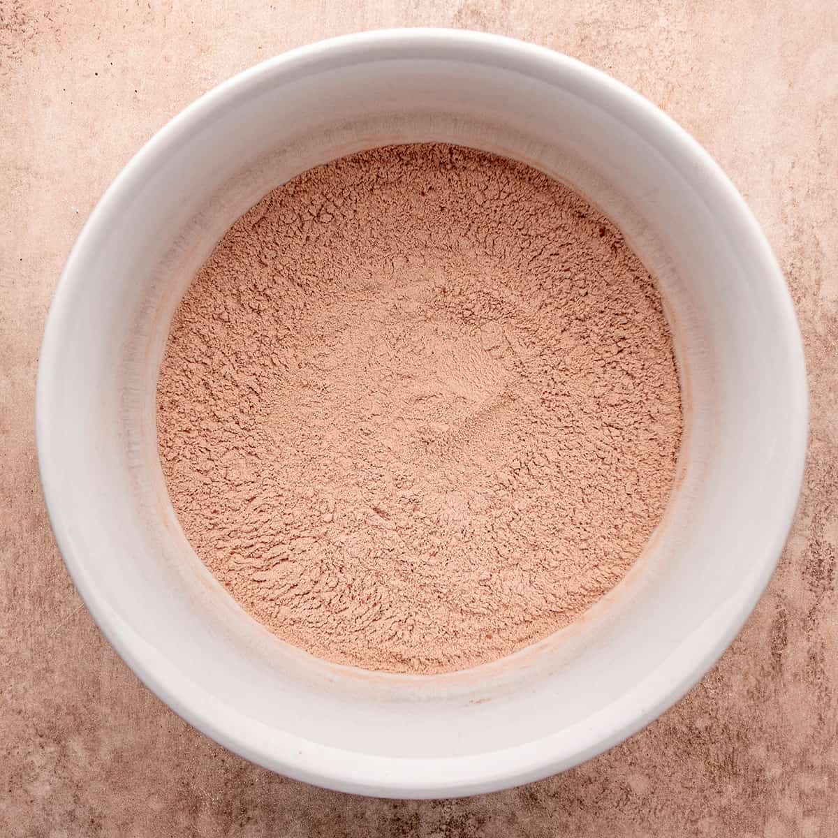 a bowl with the dry ingredients mixed together for this chocolate waffles recipe