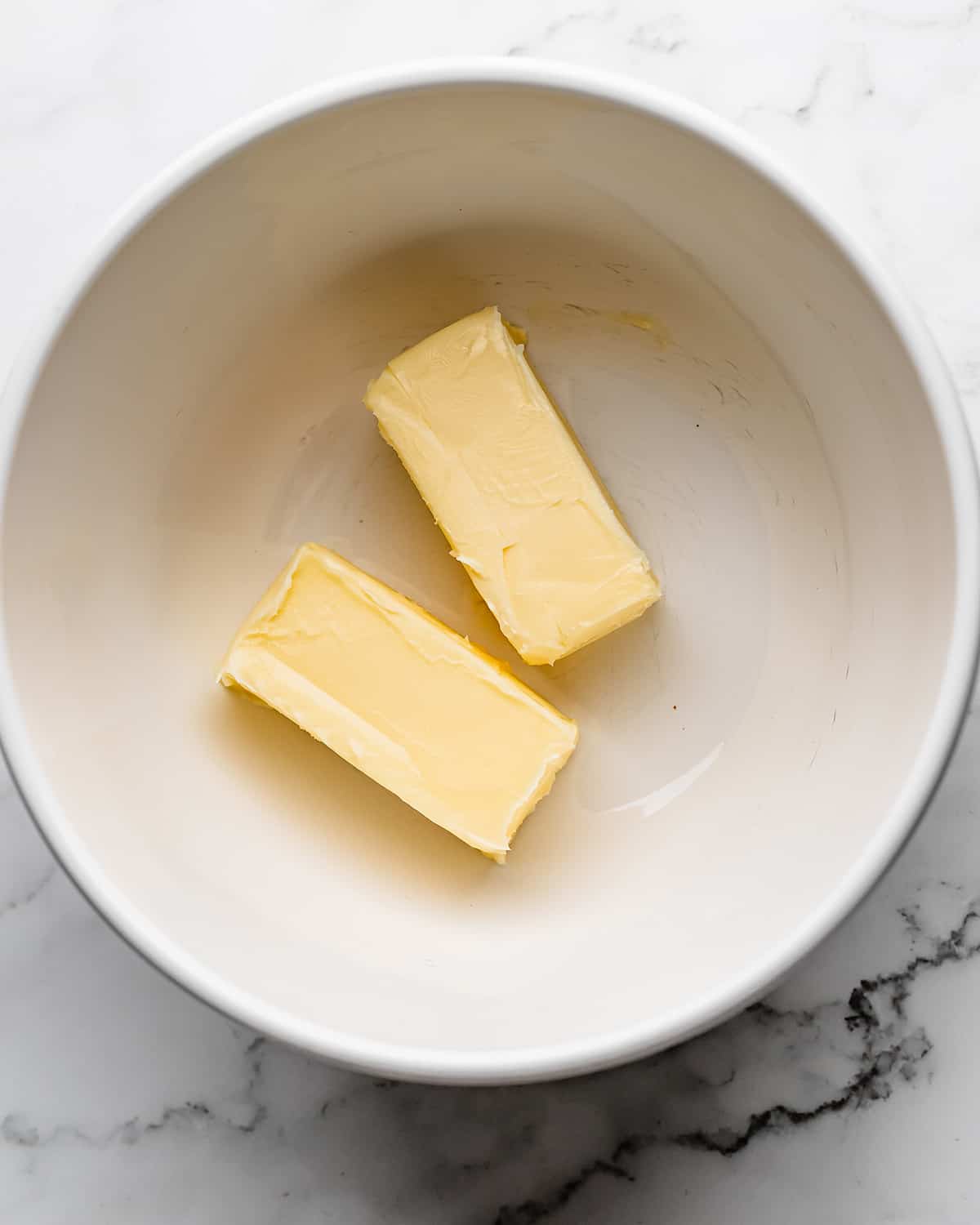 two sticks of butter in a bowl before beating