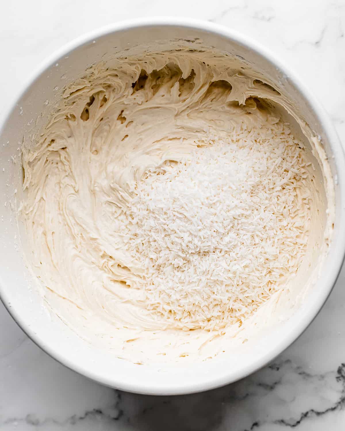 making Coconut Frosting - adding shredded coconut before mixing