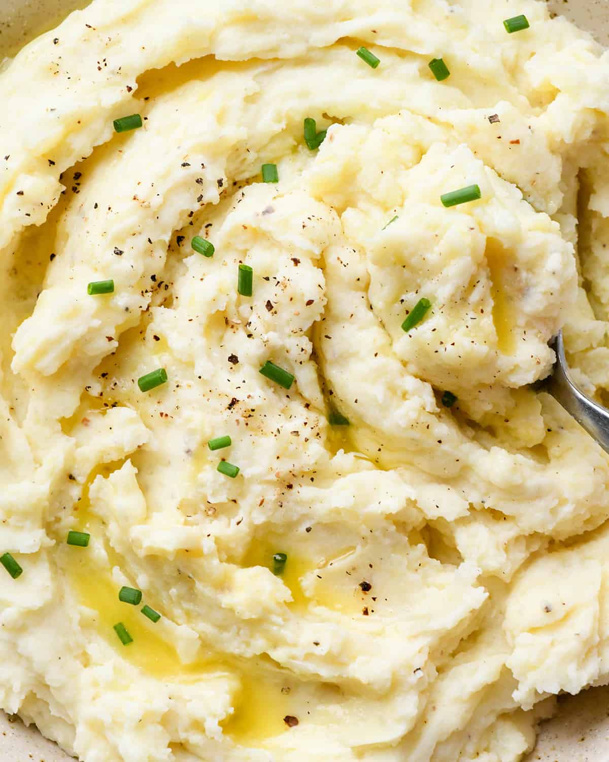 up close view of Cream Cheese Mashed Potatoes with butter, salt, pepper and chives