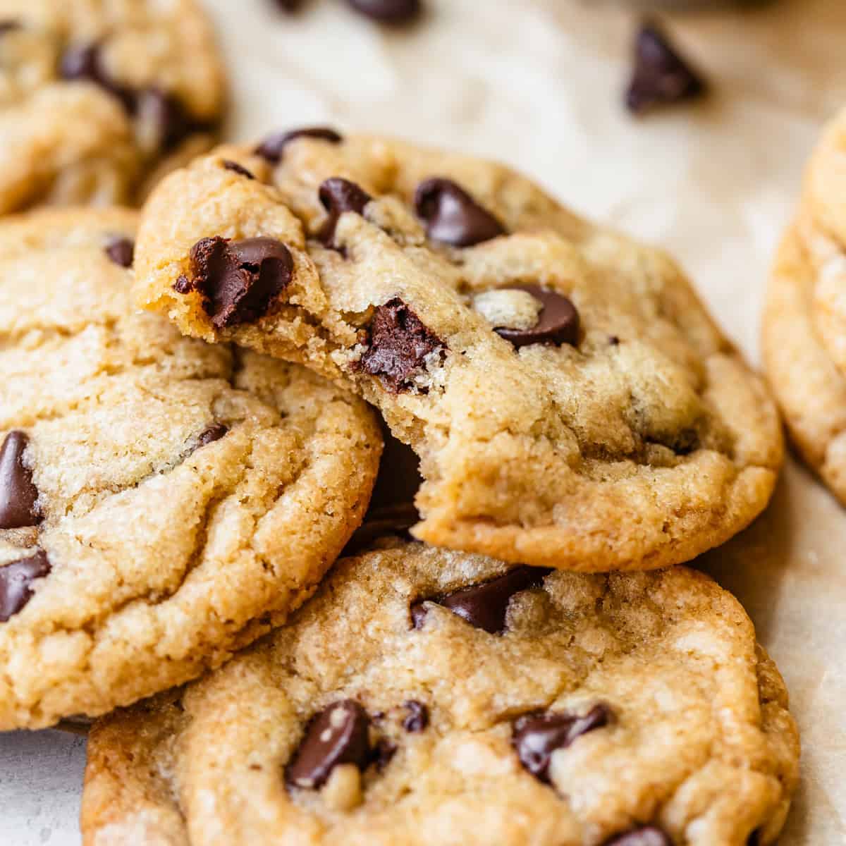4 Dairy Free Chocolate Chip Cookies, one with a bite taken out of it