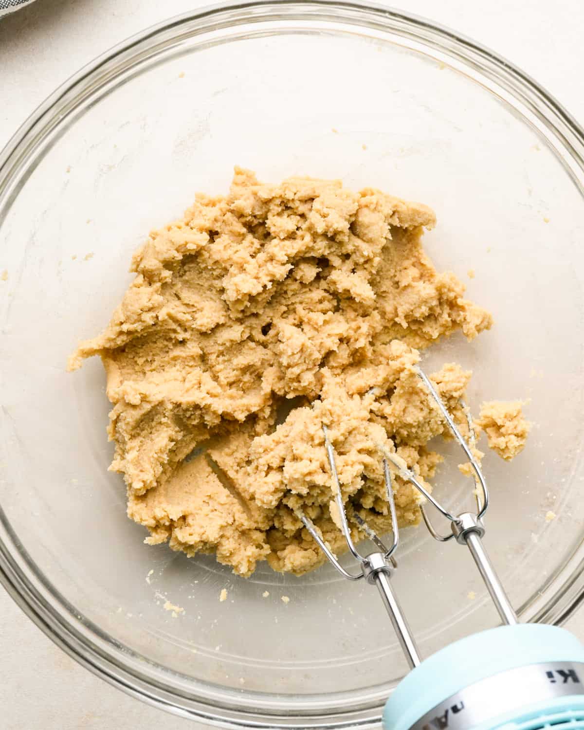 how to make chocolate cookie bars - butter, granulated sugar and brown sugar after mixing