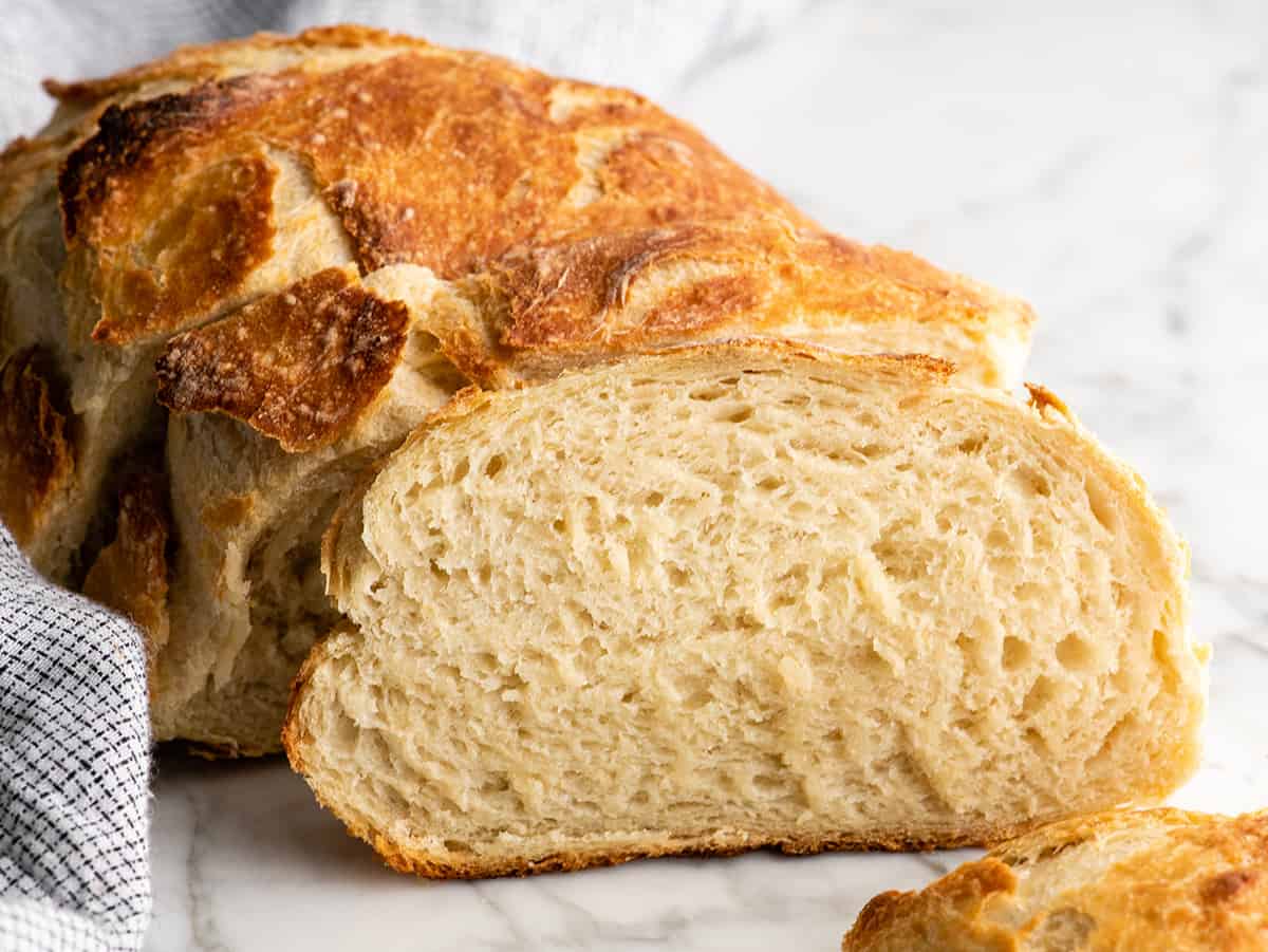 front view fo a slice of no knead bread resting on a loaf