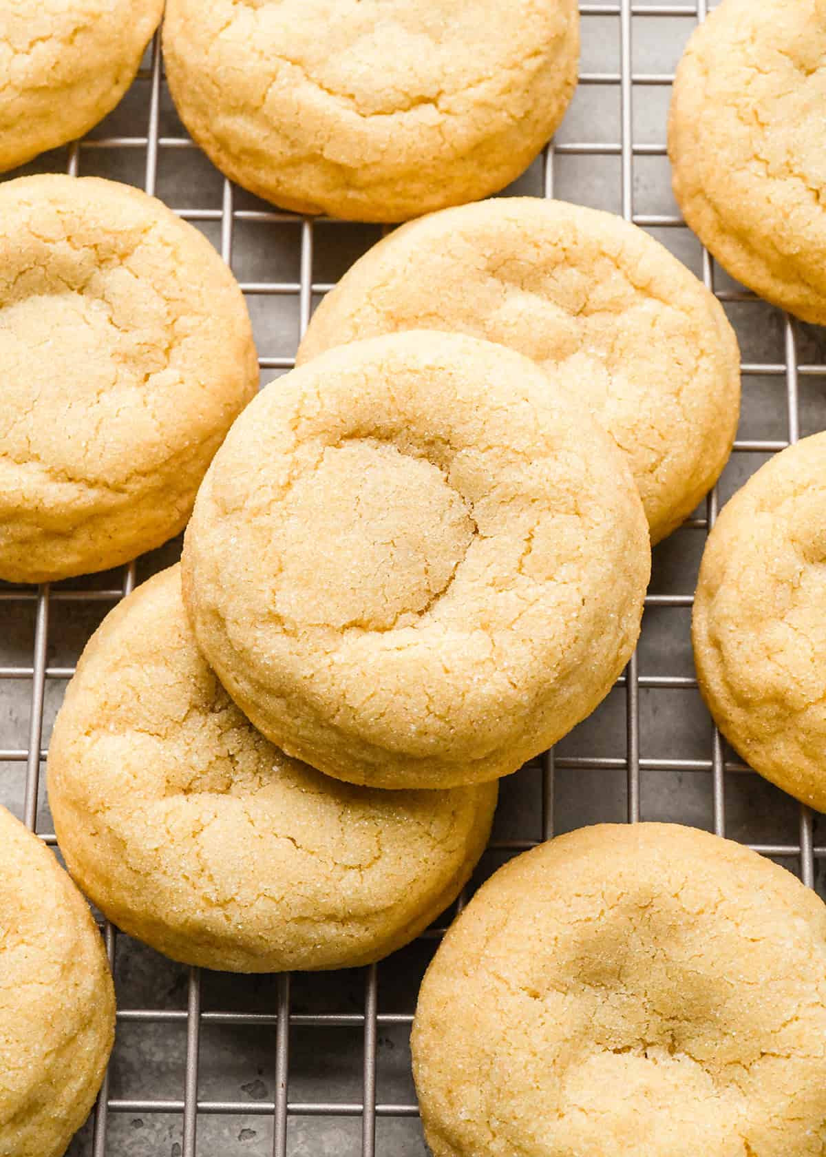 10 drop sugar cookies on a wire cooling rack after baking