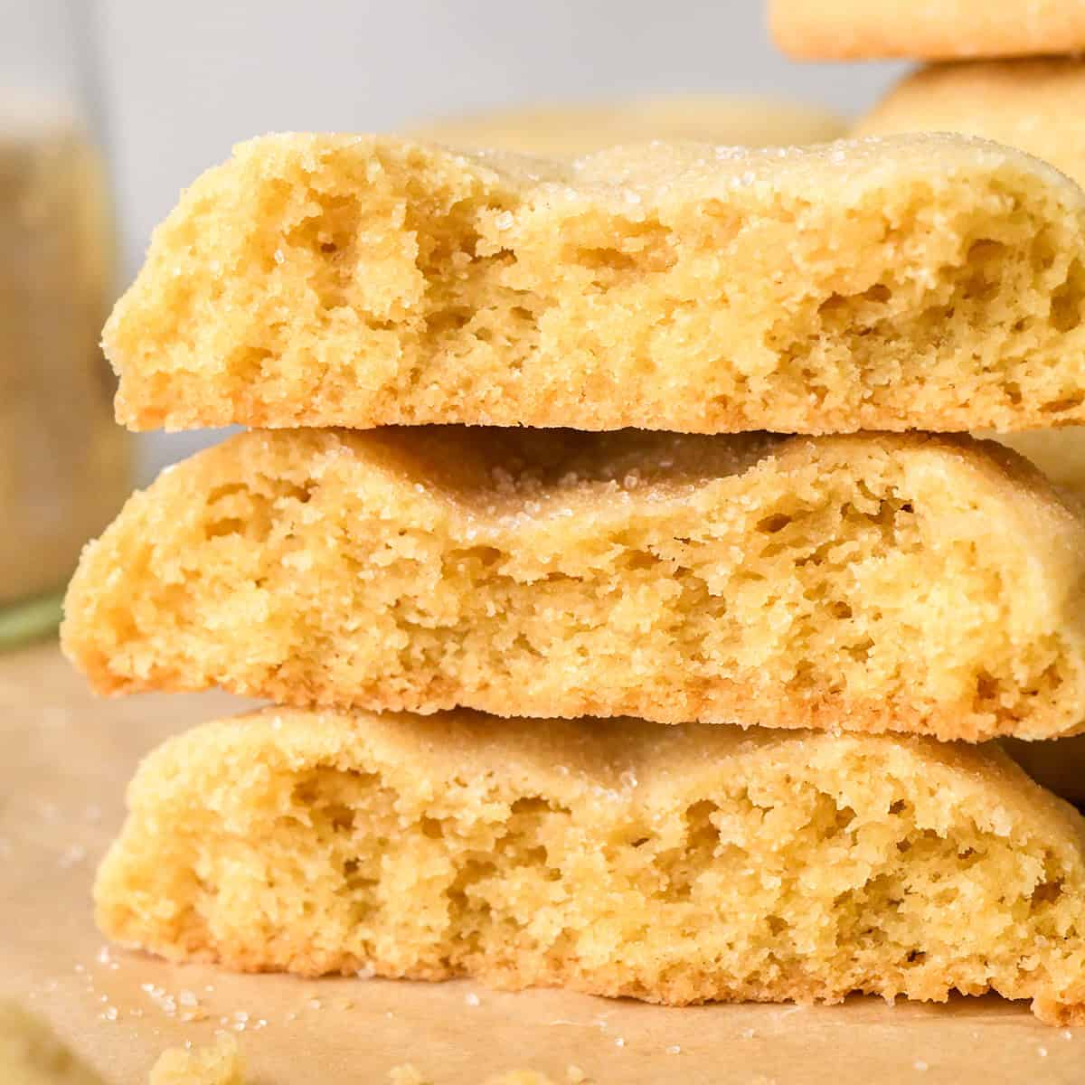 a stack of 3 Easy Sugar Cookies cut in half on parchment paper