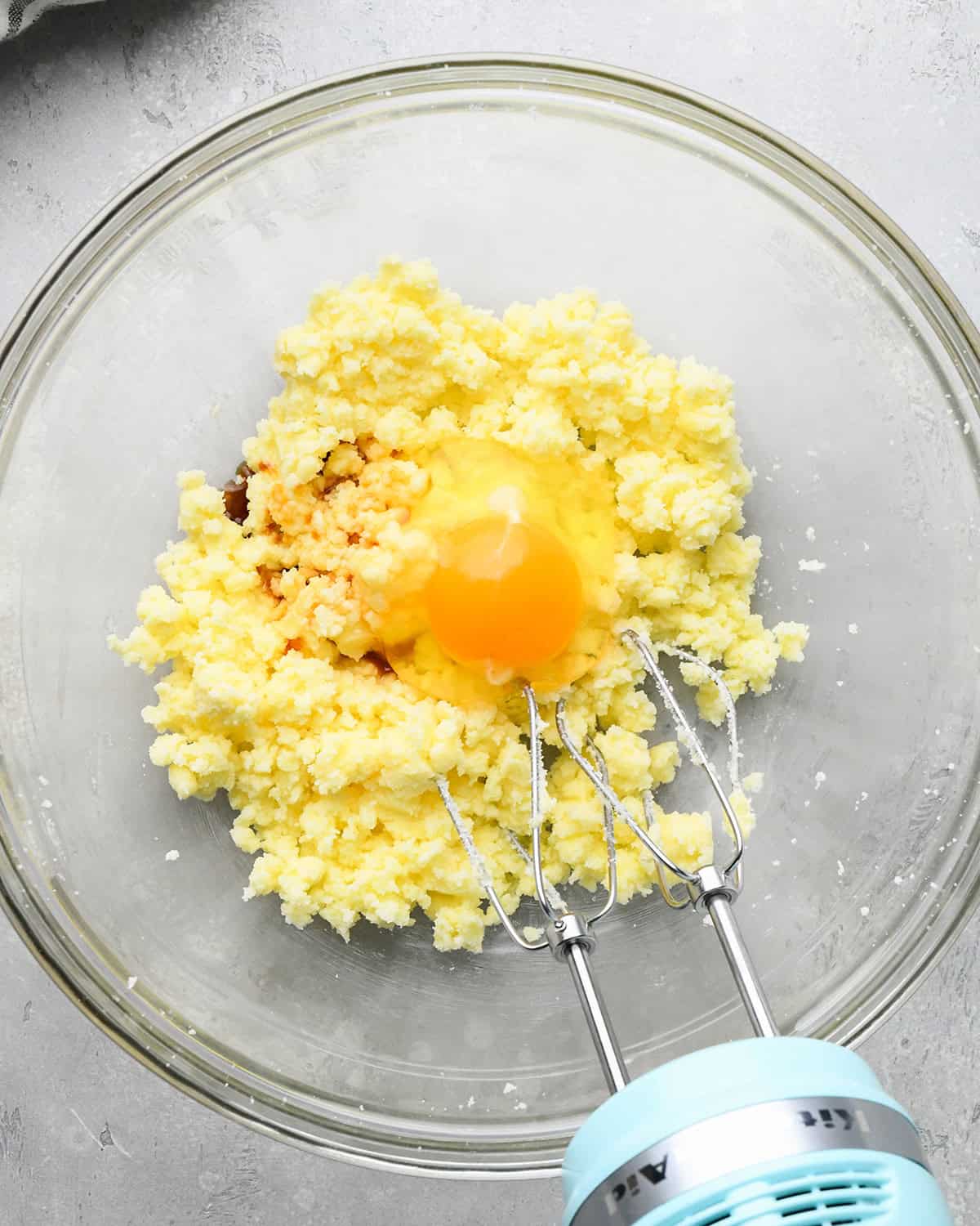 How to Make Easy Sugar Cookies - egg and vanilla added to the butter/sugar mixture before beating