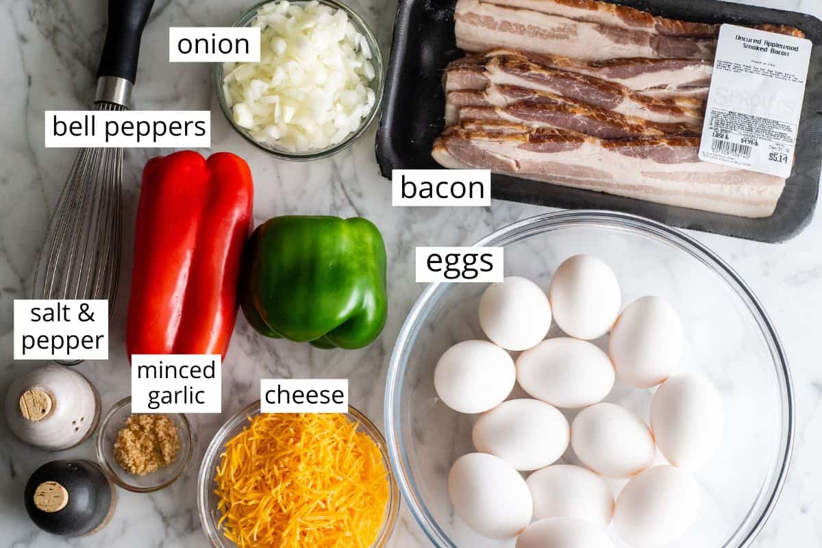This Egg Casserole (Egg Bake) is an easy breakfast casserole that's made with only 9 ingredients (eggs, veggies, bacon, cheese and seasoning)! It's a healthy, low-carb way to start the day! #eggcasserole #breakfastcasserole #bacon #eggs #breakfast #brunch #recipe #joyfoodsunshine overhead view of the labeled ingredients in this egg casserole recipe