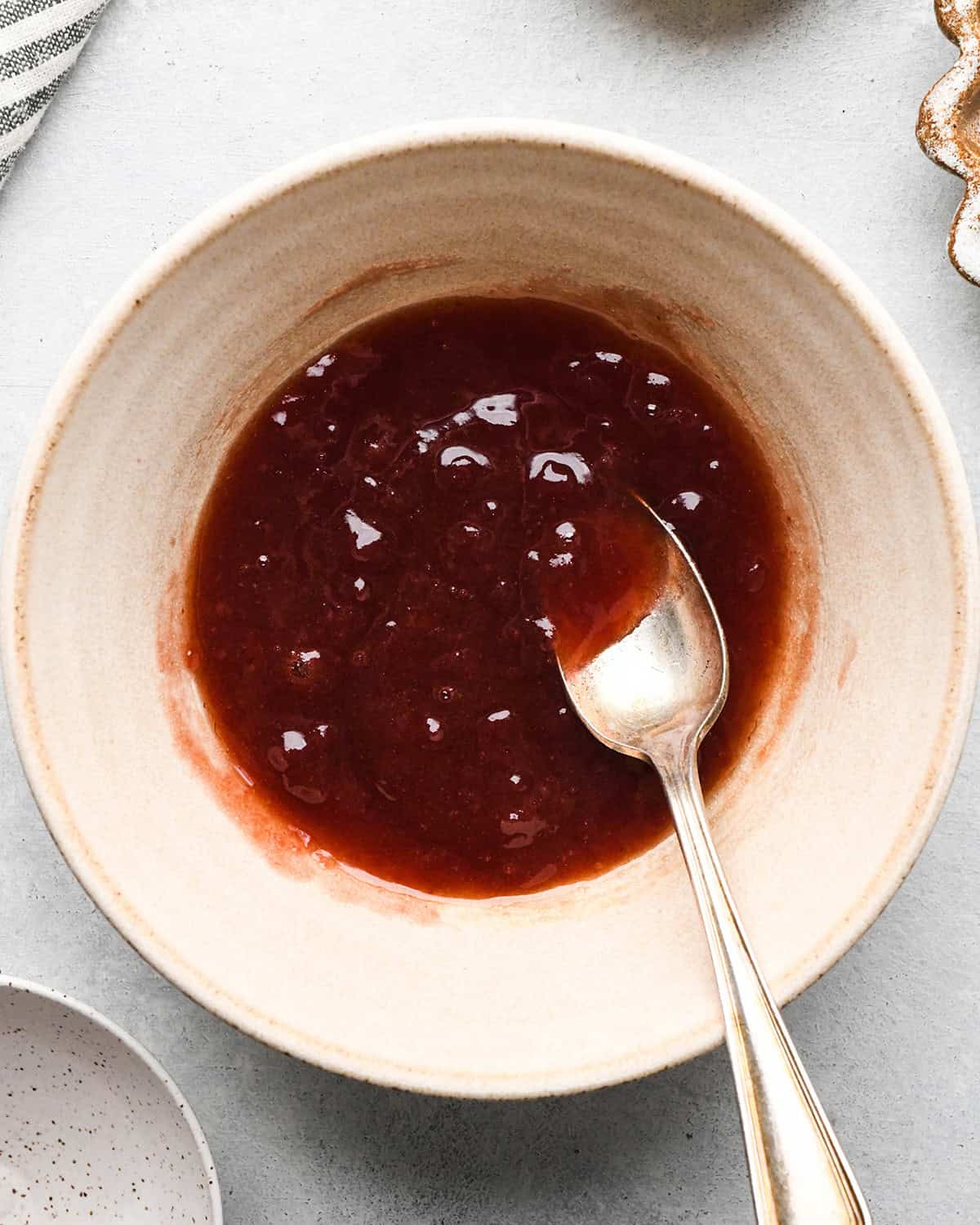 making Fruit Salsa Recipe - jam mixture in a bowl with a spoon