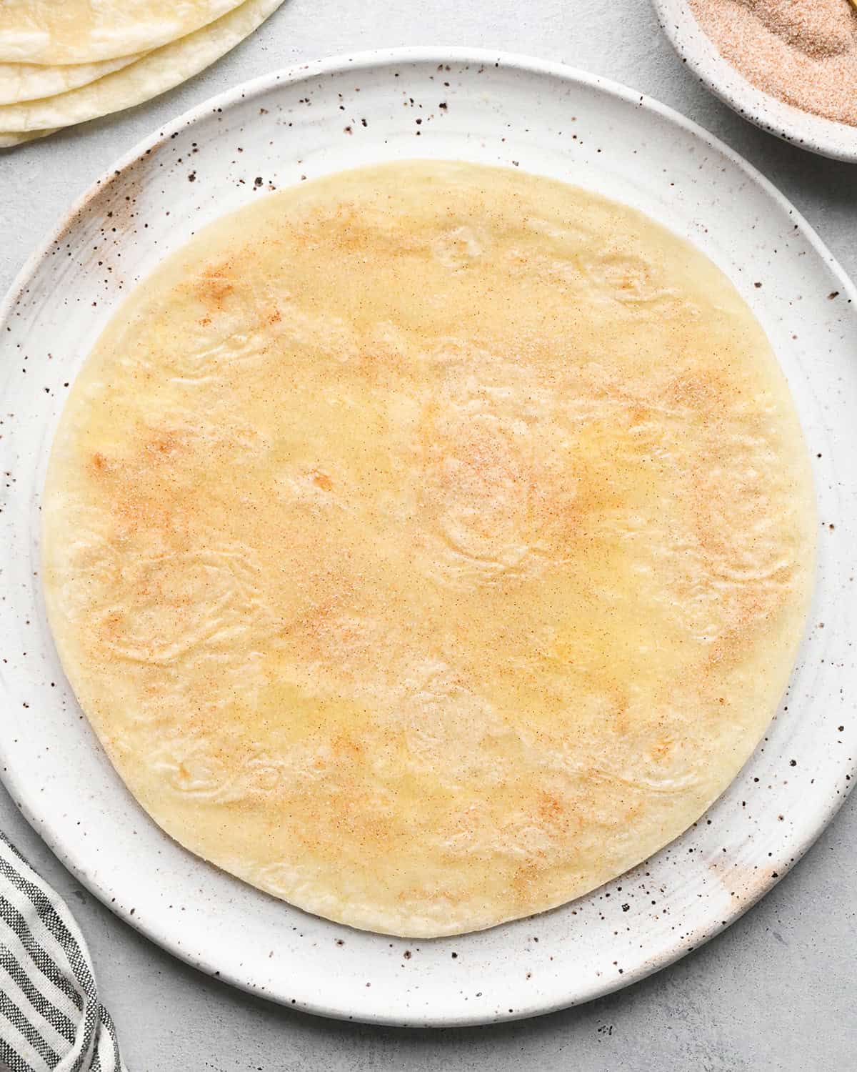 making Fruit Salsa with Cinnamon Chips - a tortilla after sprinkling cinnamon and sugar on top