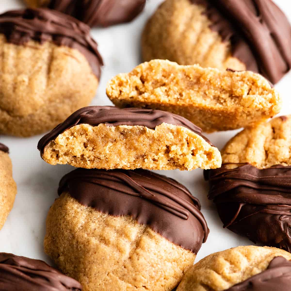 These Flourless Peanut Butter Cookies are easy to make with 4 ingredients in 15 minutes! These gluten-free peanut butter cookies are so good no one can tell they're made without flour or butter! flourless peanut butter cookie cut in half