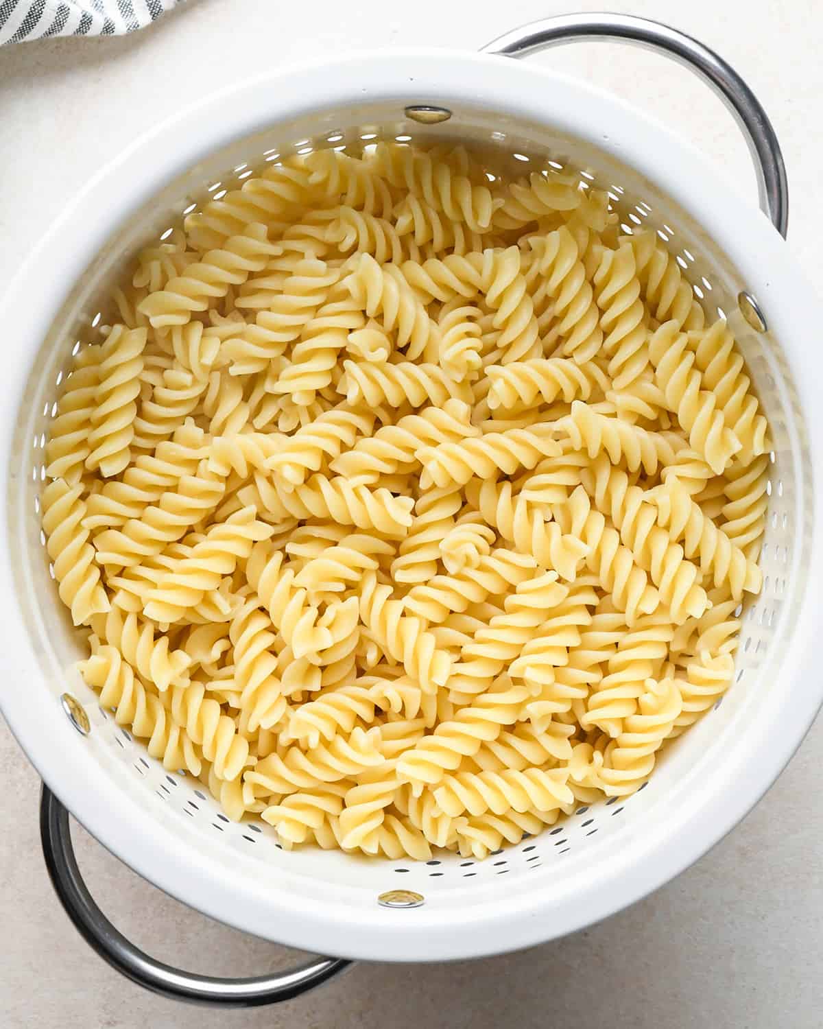 pasta in a colander to make Greek Pasta Salad