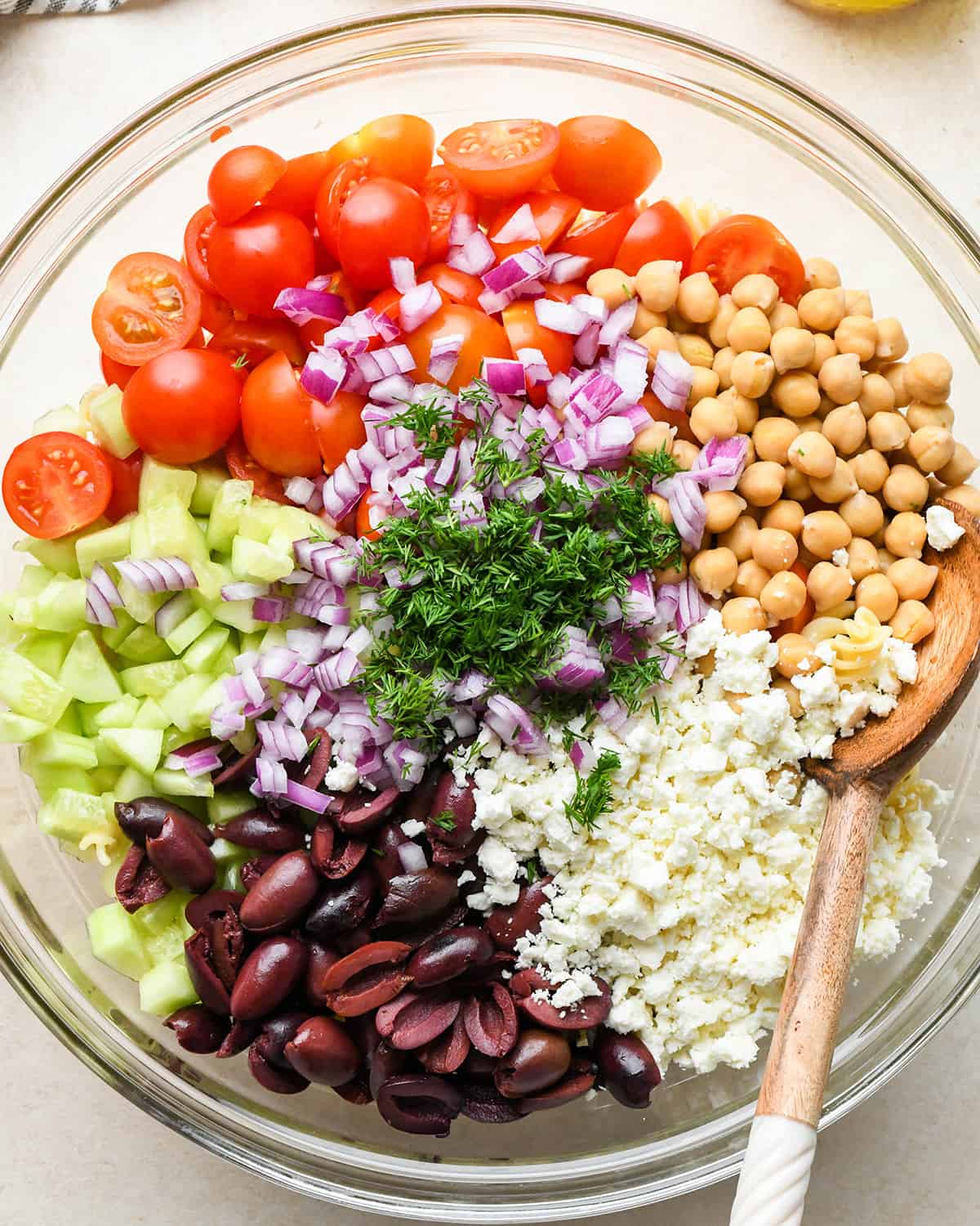 ingredients for Greek Pasta Salad Recipe in a mixing bowl before mixing