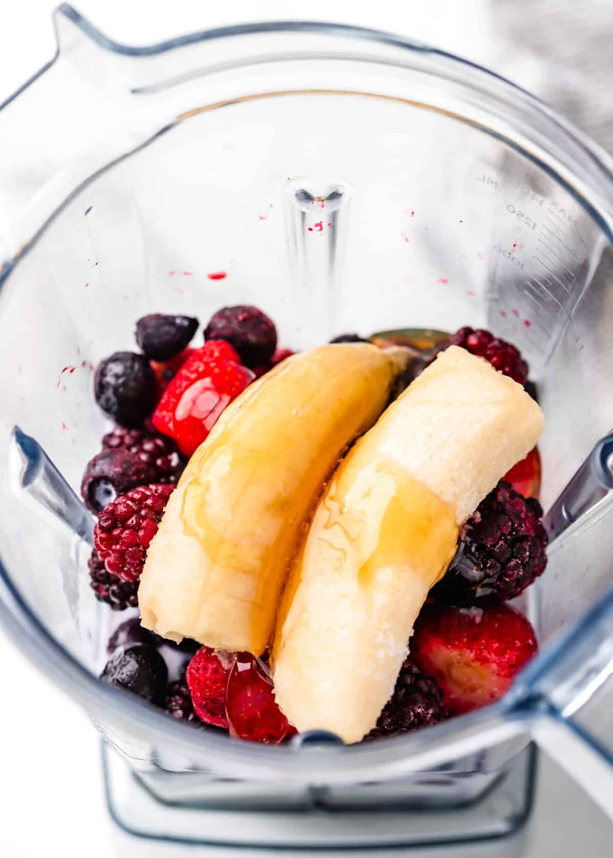overhead view of Greek Yogurt Smoothie ingredients in a blending container before blending
