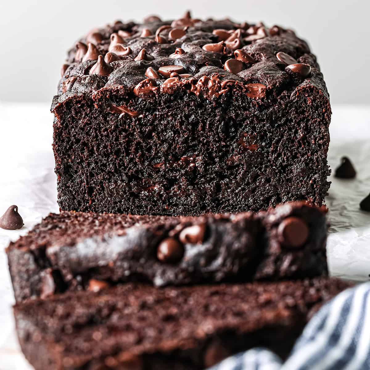 a loaf of Healthy Chocolate Banana Bread with two slices cut out of it.