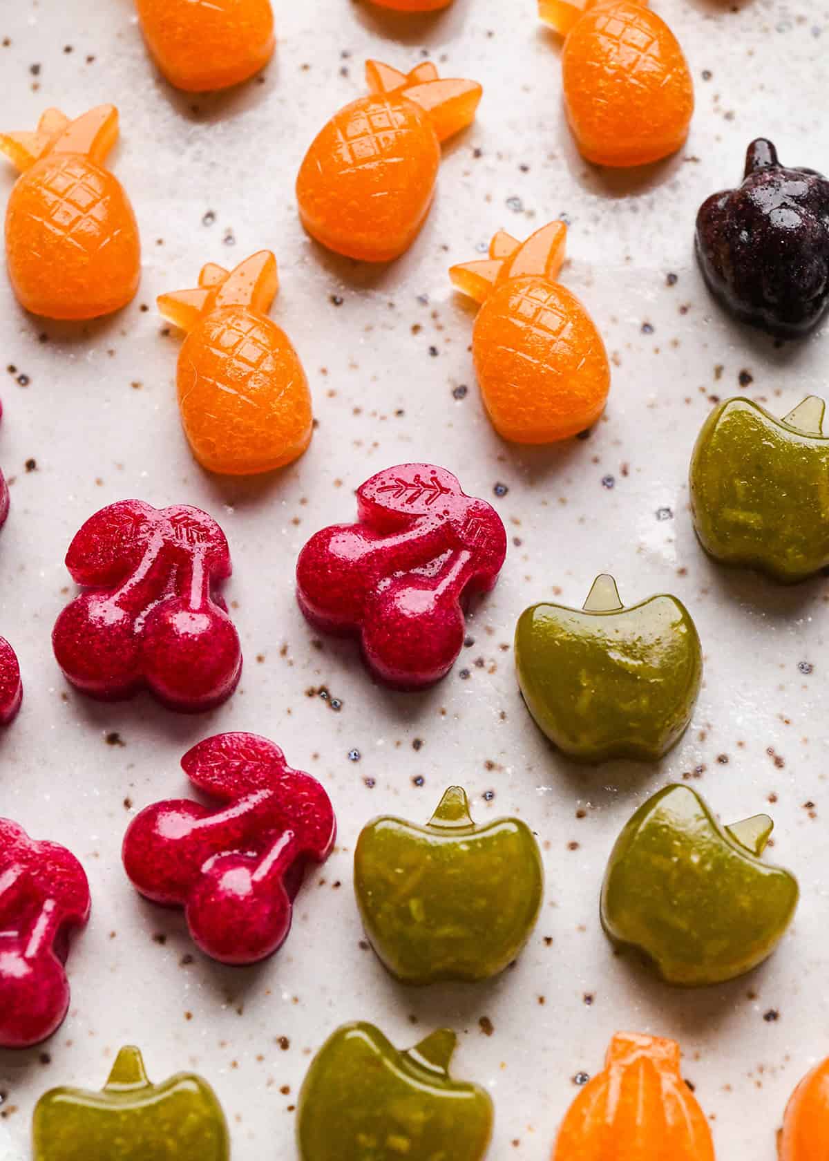 Homemade Fruit Snacks recipe made with whole fruits & vegetables! A healthy, high-protein snack loaded with nutrients made in the blender! #paleo #glutenfree #grainfree #dairyfree #refinedsugarfree #healthysnack #fruitsnacks #homemade #kidfriendly #snacktime Homemade Fruit Snacks spread out on a baking sheet