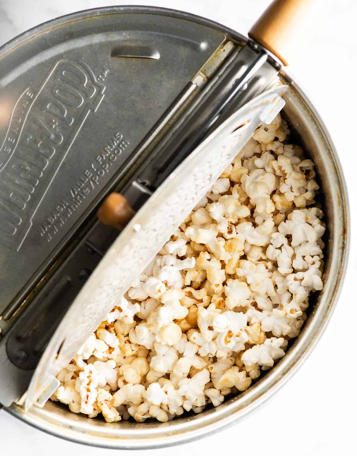 This easy homemade Kettle Corn Recipe is made with 4 ingredients, in less than 5 minutes on the stovetop. Better than the kettle corn at the fair! It's gluten-free and dairy-free! overhead view showing how to make kettle corn