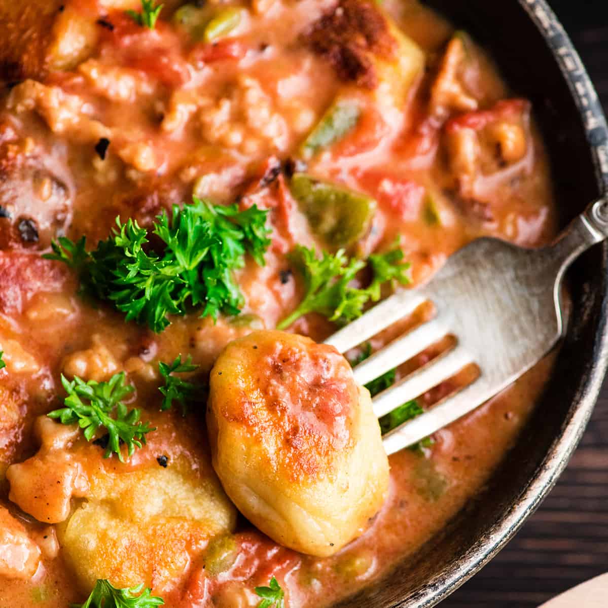 overhead view of a piece of potato gnocchi in sauce
