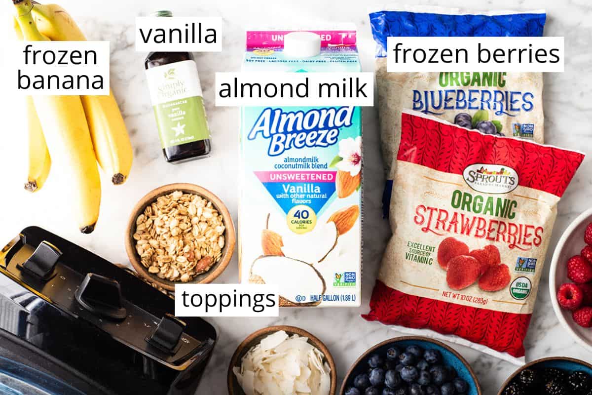 Follow our step-by-step photos & video to learn how to make the BEST easy & healthy smoothie bowl recipe (3 varieties) with 5 ingredients in 5 minutes! Smoothie bowls make the best breakfast, brunch or snack, and you can save so much money making them at home! Paleo, dairy-free and vegan-friendly. overhead view of the labeled ingredients in this smoothie bowl recipe