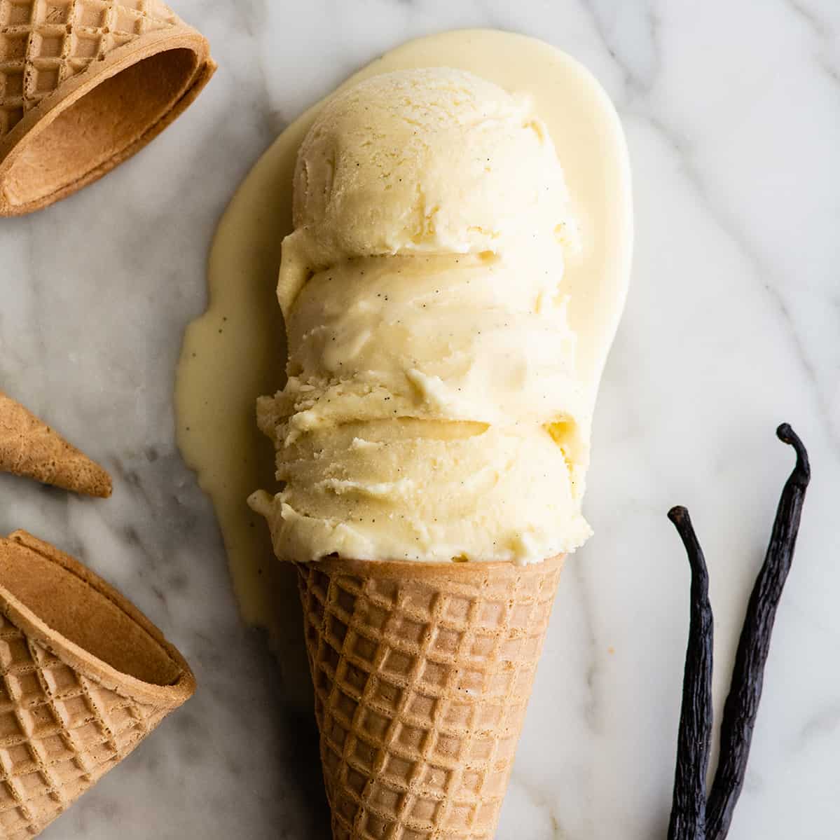 This homemade vanilla ice cream recipe is rich and creamy with a deep vanilla flavor. Watch the video and follow our step-by-step instructions to learn how to make this 5-ingredient vanilla bean ice cream recipe! 3 scoops of vanilla ice cream on a sugar cone