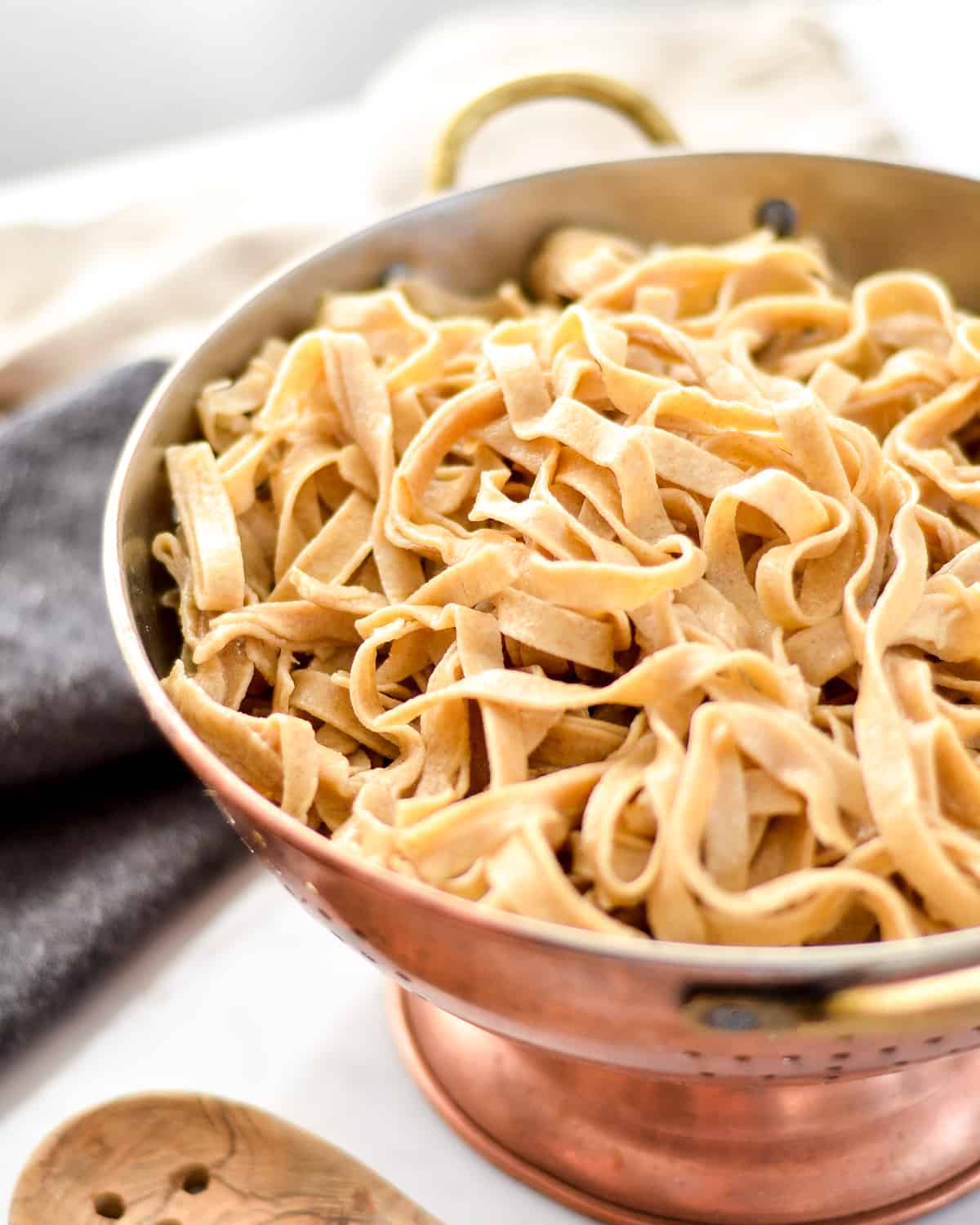 a colander filled with Homemade Whole Wheat Pasta noodles after cooking