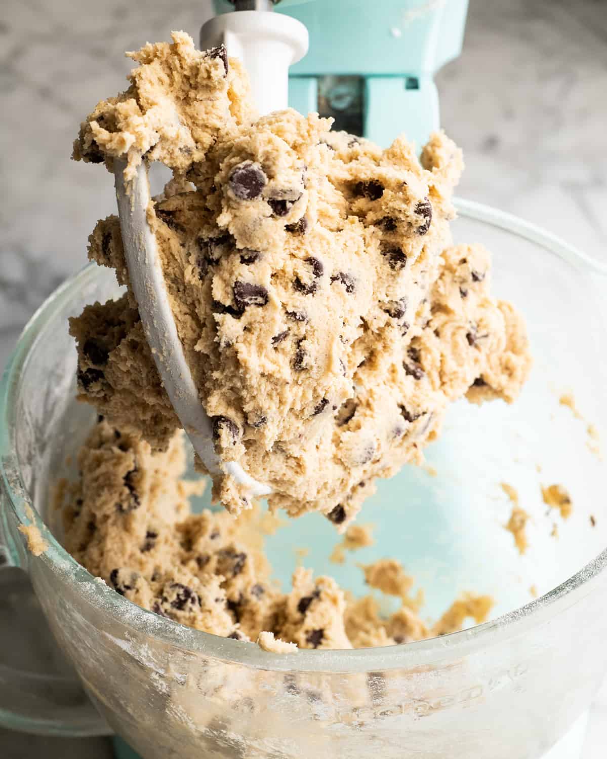 This chocolate chip cookie cake recipe is soft, chewy, slightly doughy and decorated with the best chocolate buttercream frosting. It's easy to make, large enough to feed a crowd, and even better than store-bought! photo showing How to Make a Cookie Cake