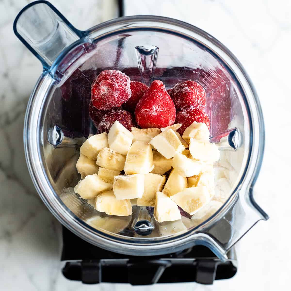 Follow our step-by-step photos & video to learn how to make the BEST easy & healthy smoothie bowl recipe (3 varieties) with 5 ingredients in 5 minutes! Smoothie bowls make the best breakfast, brunch or snack, and you can save so much money making them at home! Paleo, dairy-free and vegan-friendly. overhead photo showing how to make a smoothie bowl